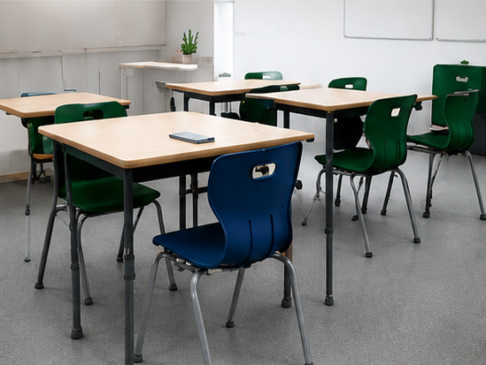Classroom with timber-top student desks and navy and green chairs